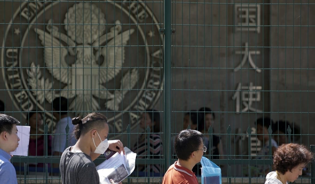 Chinese visa applicants outside the US embassy in Beijing. Photo: AP