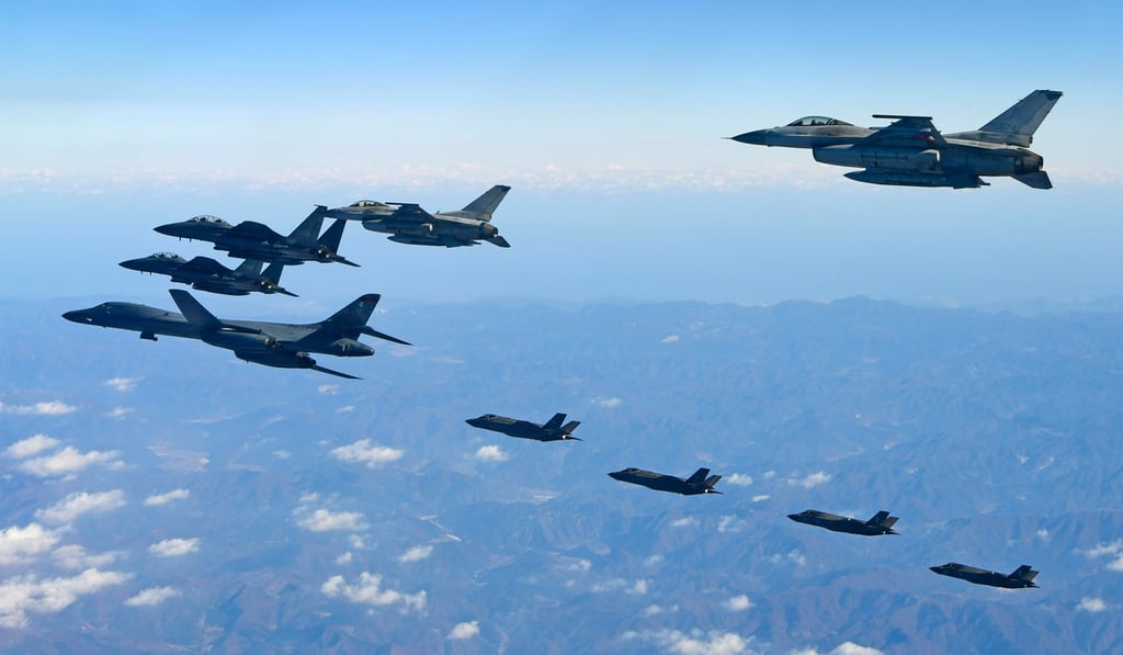 A photo released by South Korea’s Ministry of National Defence shows US Air Force jets (left) flying with South Korean war planes. The US spent US$590 billion on defence in 2017, but far less on climate change over two decades. Photo: AFP