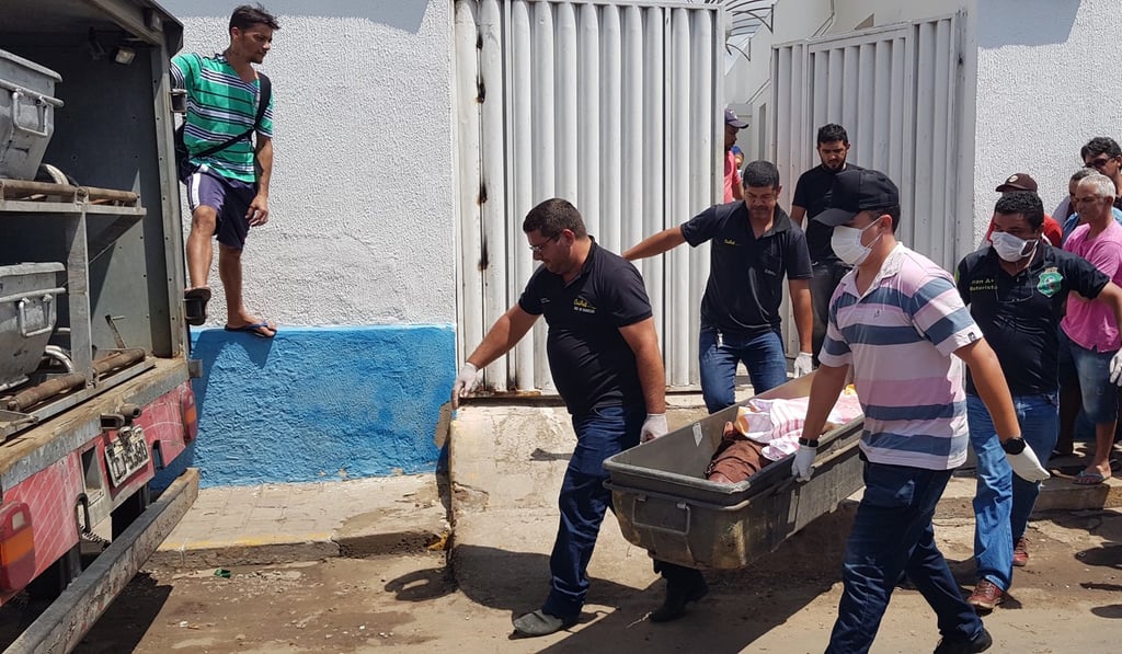 People carries the body of one of the victims of the shooting in Milagres, Brazil on December 7, 2018. Photo: EPA
