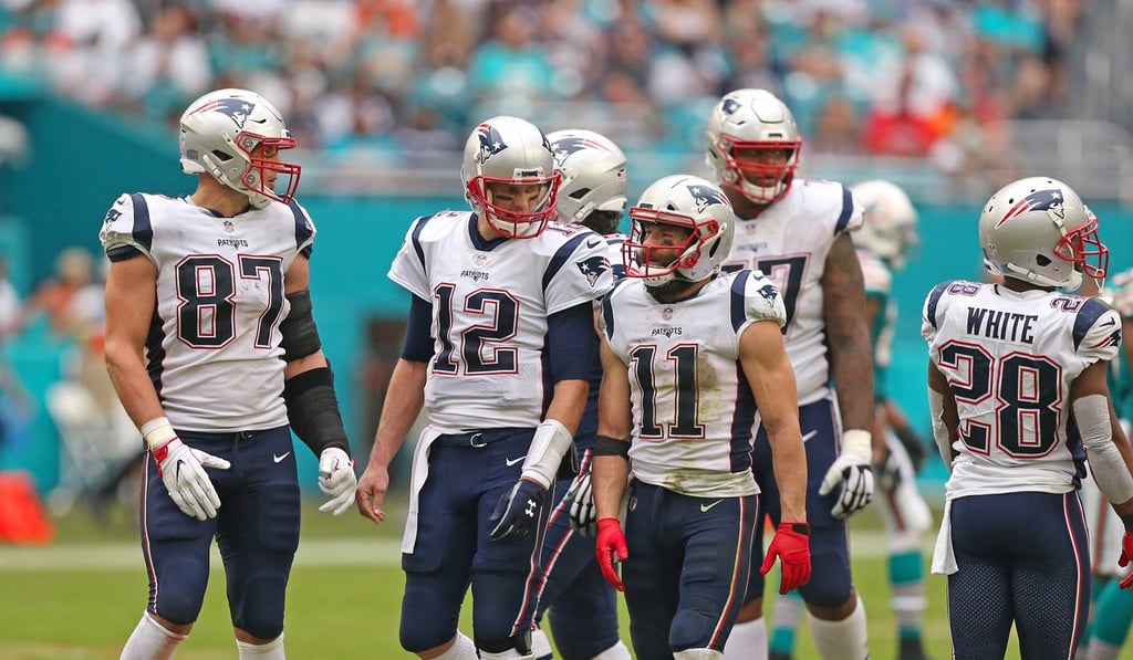 New England Patriots players Rob Gronkowski (87), Tom Brady (12) and Julian Edelman (11) talk during the third quarter of the loss against the Miami Dolphins. Photo: TNS