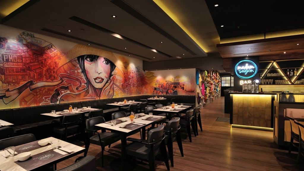 The colourful art on the walls at Madam Saigon makes a good backdrop for photos.