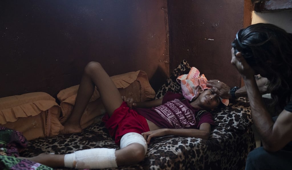 In this September 12, 2018, photo, Raed Abu Khader, right, holds a wet cloth on the forehead of his 12-year-old son Mohammed in Gaza City. Mohammed was shot in the leg at one of the demonstrations on Gaza strip's border with Israel. Photo: AP Photo/Felipe Dana In this September 12, 2018, photo, Raed Abu Khader, right, holds a wet cloth on the forehead of his 12-year-old son Mohammed in Gaza City. Mohammed was shot in the leg at one of the demonstrations on Gaza strip's border with Israel. Photo: AP Photo/Felipe Dana