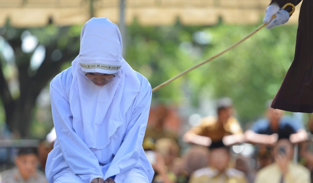 A 21-year old Muslim woman is flogged for being in close proximity with her boyfriend in Banda Aceh on October 29. Photo: AFP