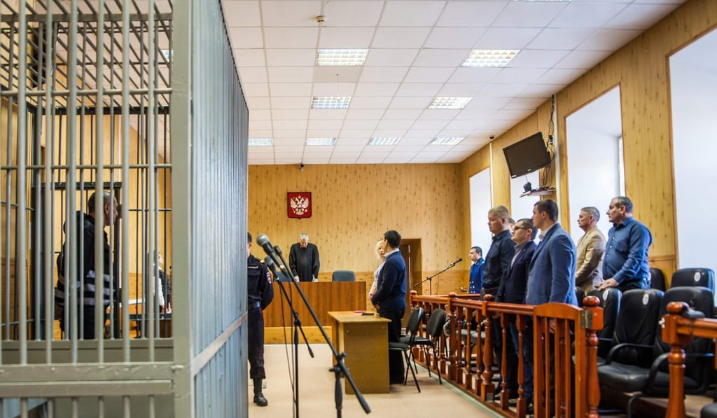 Popkov inside a defendants' cage during a court hearing in Irkutsk on Monday. Photo: AFP