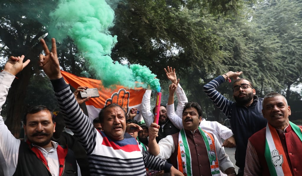 Congress supporters celebrate in Delhi. Photo: EPA Congress supporters celebrate in Delhi. Photo: EPA