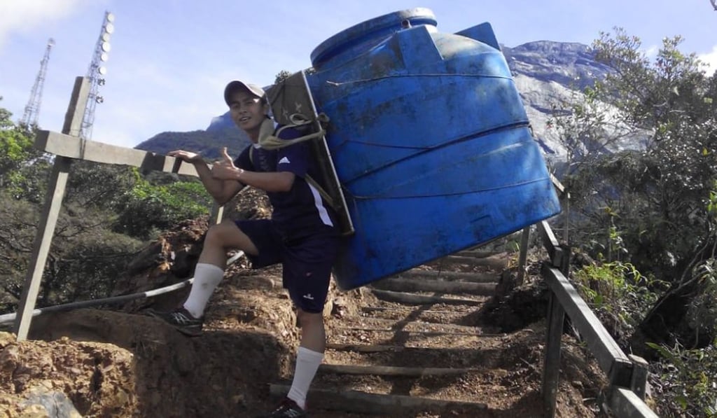 Daved Simpat carrying water up Mount Kinabalu.