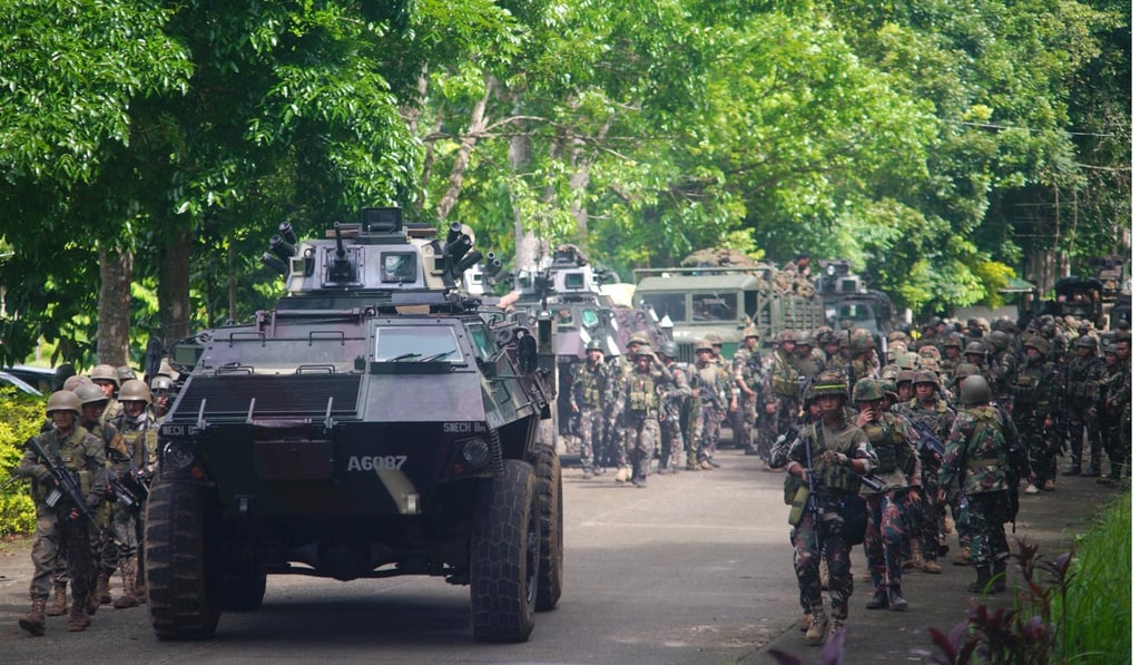 Soldiers take position following clashes between government troops and rebels in Marawi City last May. Photo: EPA