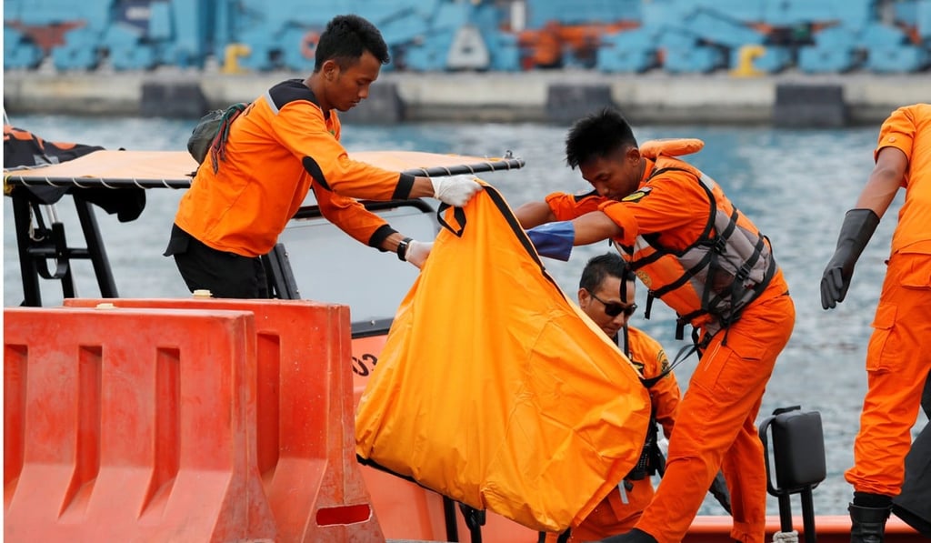 A salvage team carry a bag containing the body of a passenger from the Lion Air flight. Photo: Reuters
