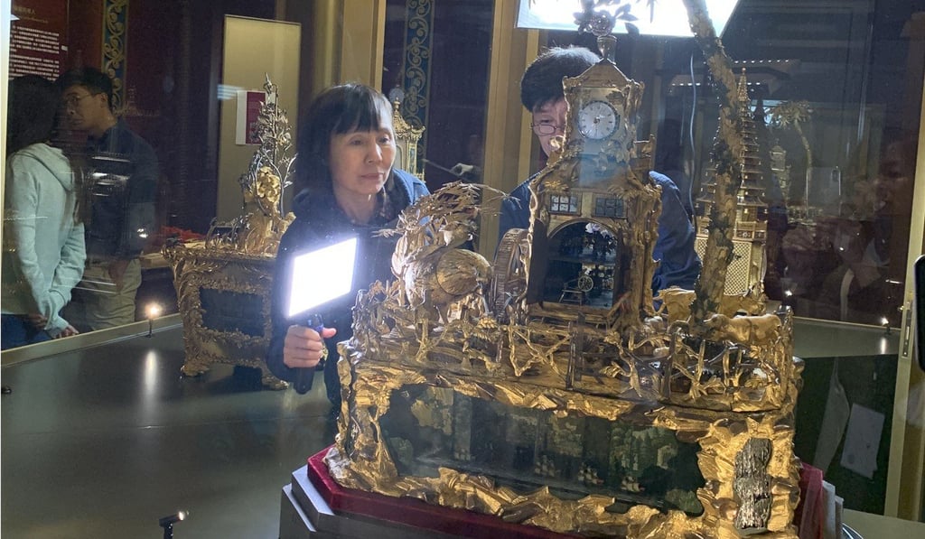 Guan Xueling (left) and Wang Jin, both research fellows at The Palace Museum in Beijing, prepare the Emperor Qianlong’s clock for the start of the ‘Treasures of Time’ exhibition, which is being held at the Hong Kong Science Museum. Photo: The Palace Museum