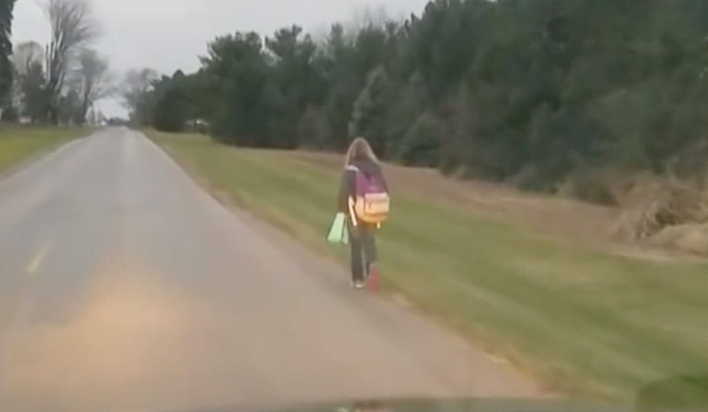 An American father made his 10-year-old daughter walk to school in the freezing cold as punishment for bullying classmates, and drove alongside videoing her.