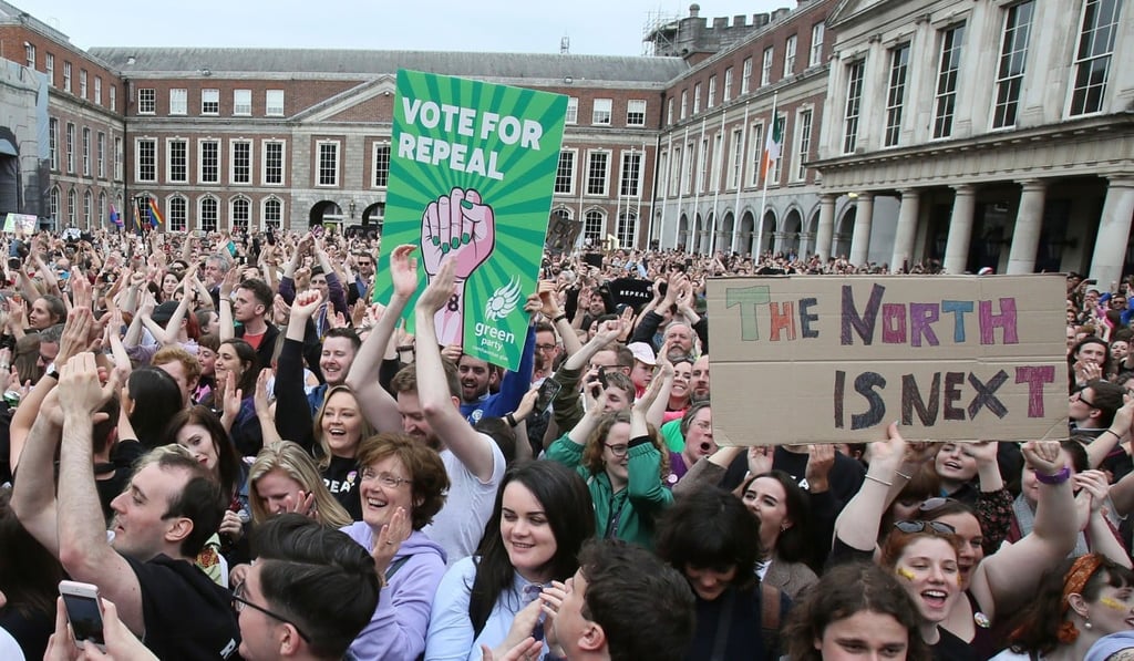 “Yes” campaigners hold posters calling for British-ruled Northern Ireland to liberalise its strict abortion laws, as they celebrate the official result in the Irish abortion referendum vote at Dublin Castle on May 26. Photo: AFP