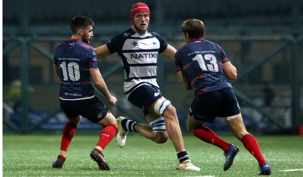 Fin Field (centre) of Hong Kong Football Club face HK Scottish. Photo: Jonathan Wong