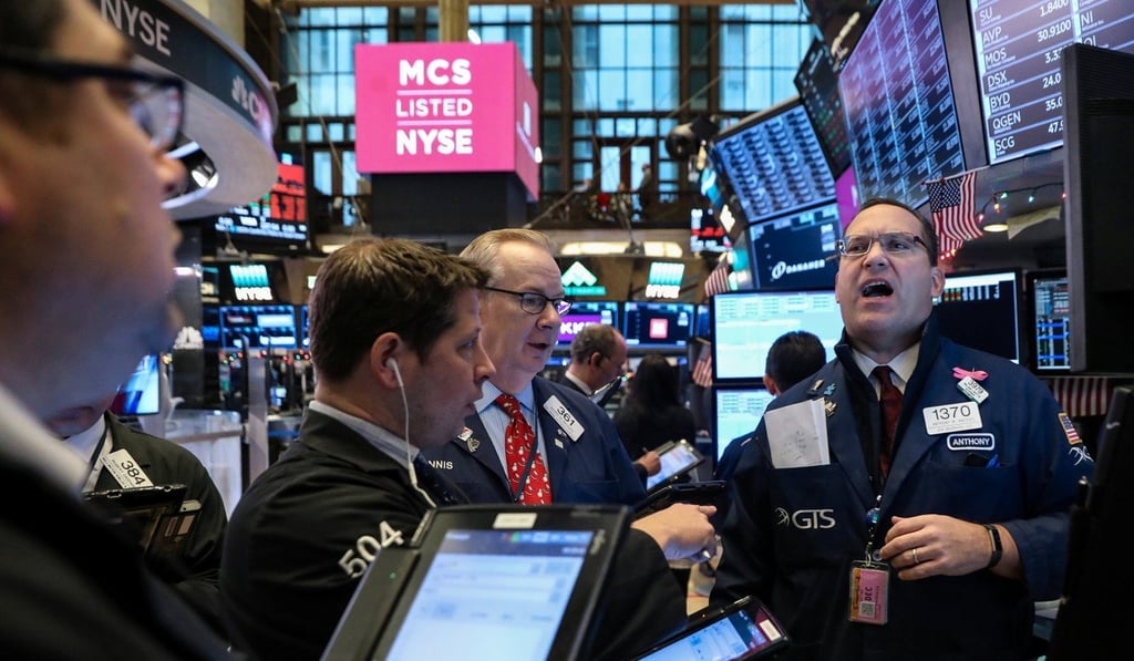 Traders and financial professionals work on the floor of the New York Stock Exchange on Friday. Photo: Reuters