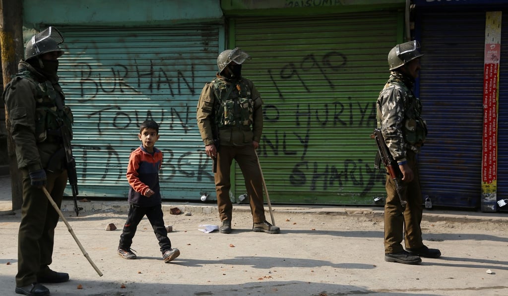 Indian policemen stand near closed shops in Srinagar. Photo: AP Indian policemen stand near closed shops in Srinagar. Photo: AP