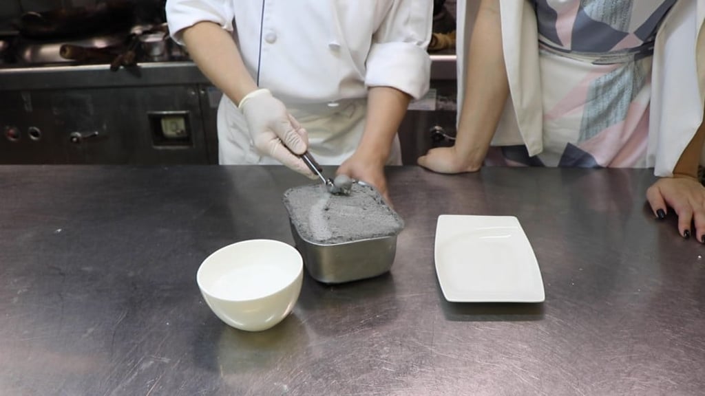Scooping out the small round balls of the filling.