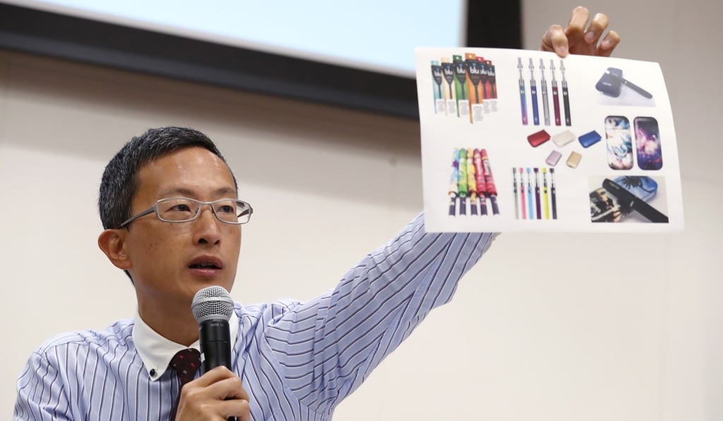 Dr David Lam Tzit-yuen, honorary secretary of the Hong Kong Medical Association, holds up a chart showing vaping devices in calling for a total ban on electronic cigarettes and other new tobacco products, in June. Photo: Nora Tam