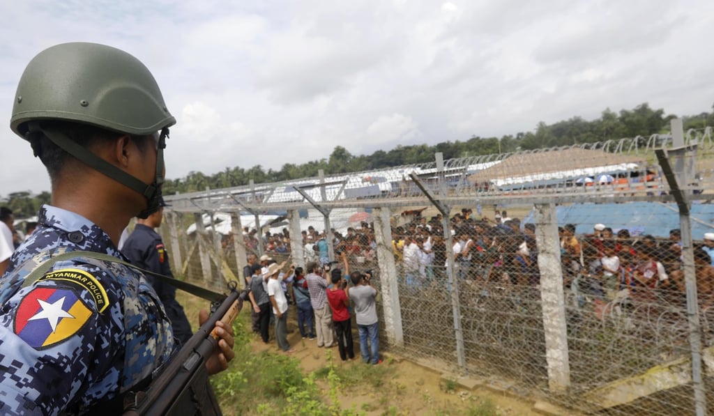 A Myanmar border guard stands near a fence in Maungdaw township. Photo: EPA