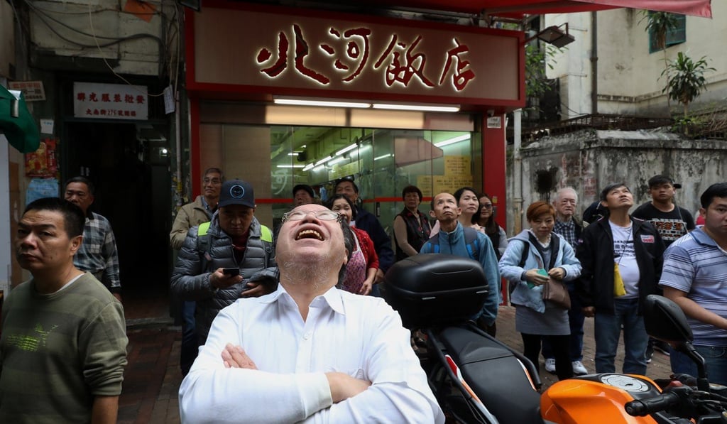 A bystander at the scene where HK$100 notes were thrown off a building. Photo: Sam Tsang