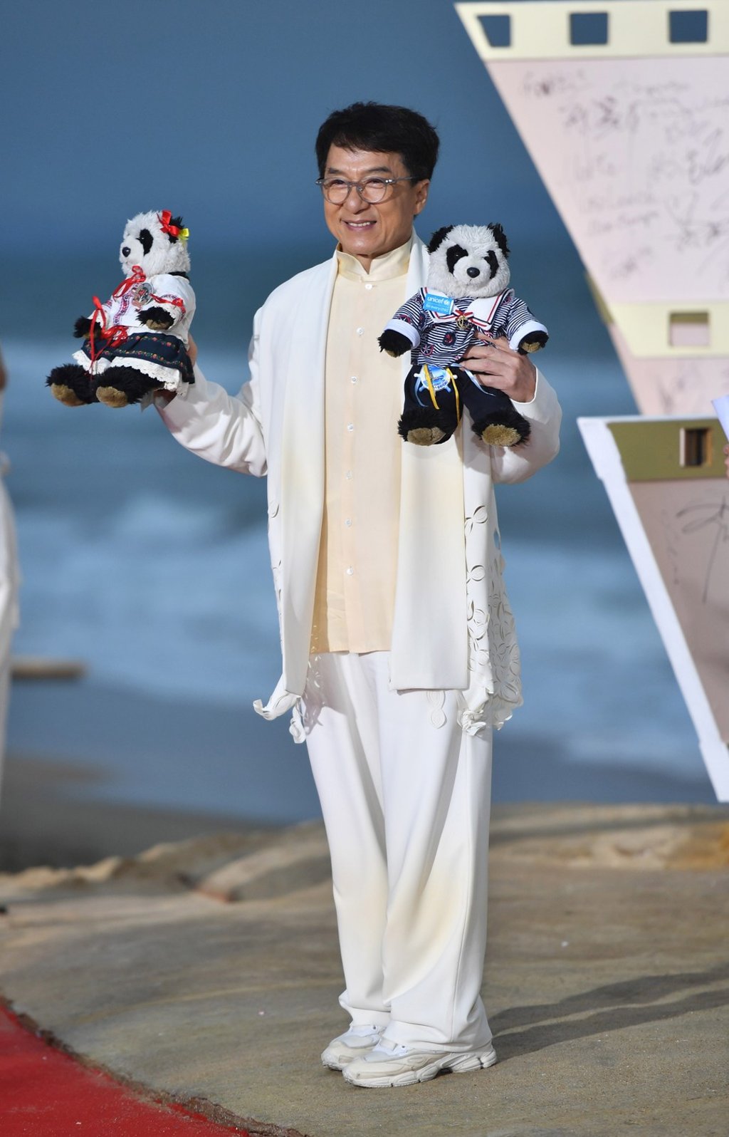 Actor Jackie Chan, wearing white sneakers, hit all the right notes at the red carpet ceremony in Sanya. Photo: Xinhua