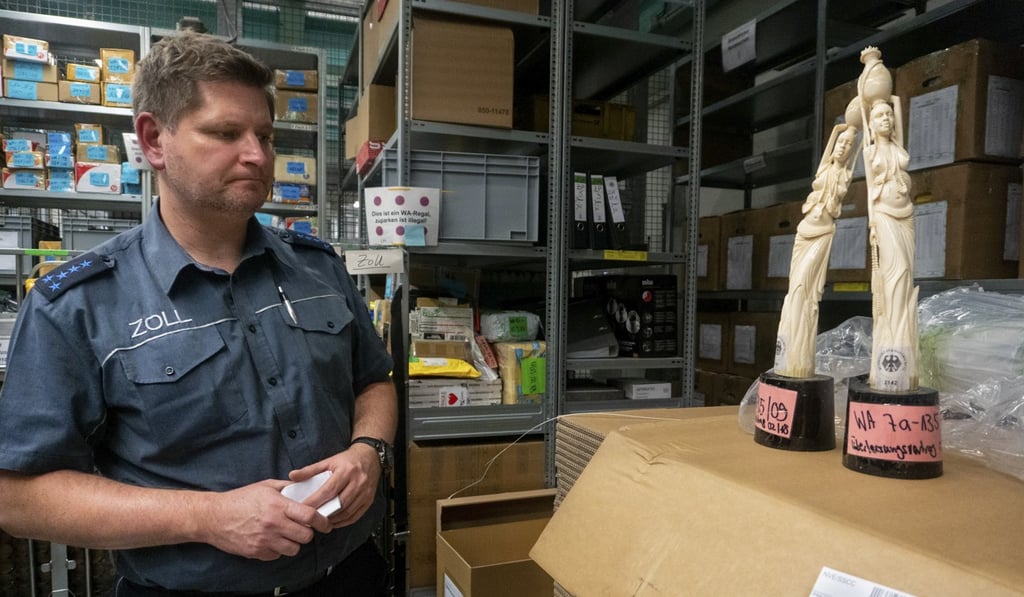 Customs officer Marcus Redanz with statues made of ivory seized by his team at the International Postal Centre, in Frankfurt, Germany. Picture: Denise Hruby
