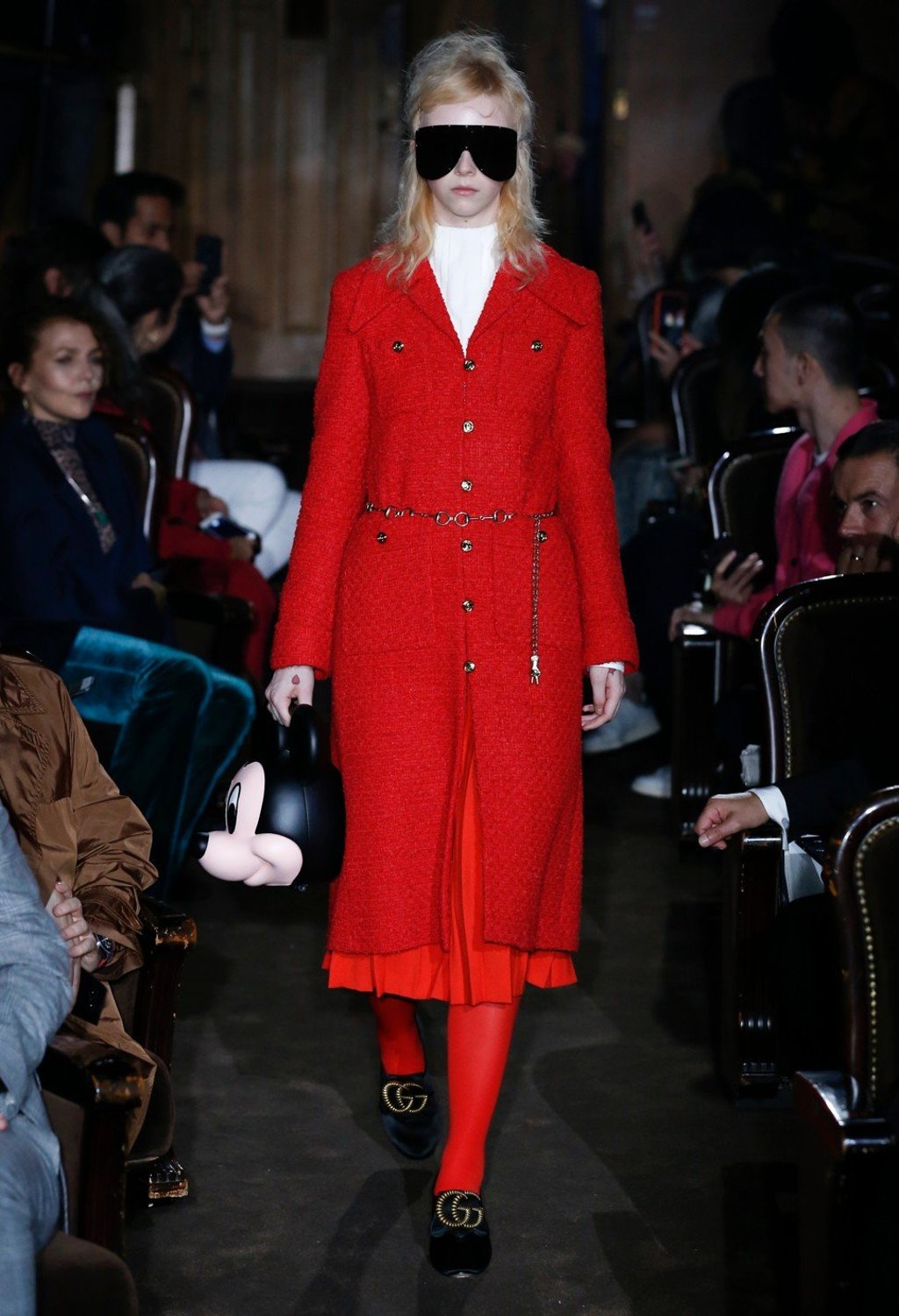 A Gucci catwalk model carries a handbag made to look like the head of iconic Disney character Mickey Mouse, which celebrates its 90th anniversary this year. A Gucci catwalk model carries a handbag made to look like the head of iconic Disney character Mickey Mouse, which celebrates its 90th anniversary this year.