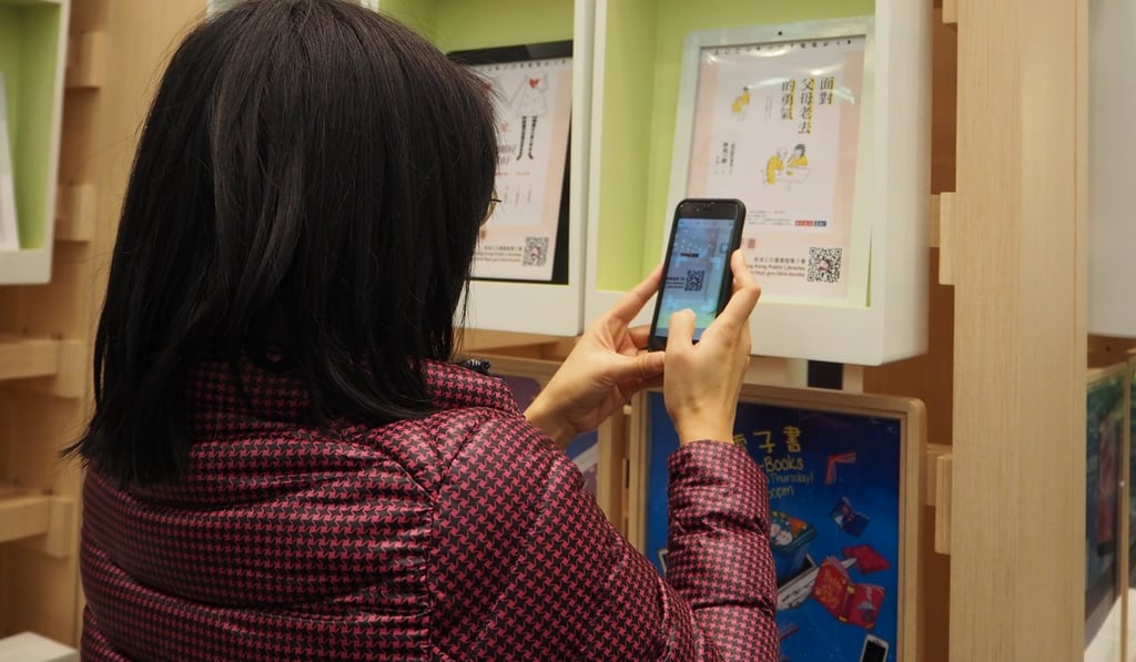 A reader scans the QR code of an electronic book at Hong Kong Central Library.