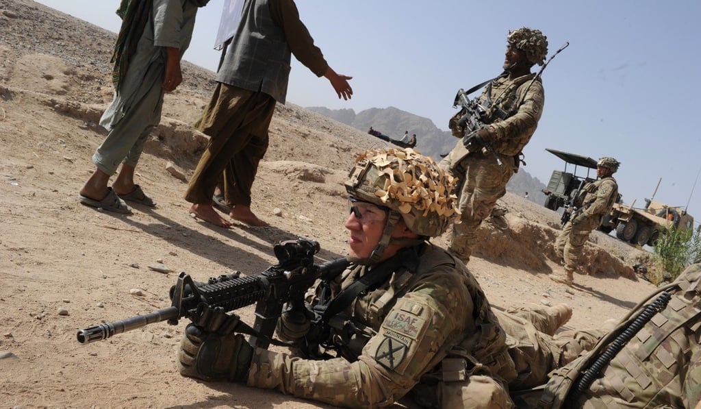 American soldiers greet Afghan villagers in Kandahar province. Photo: AFP
