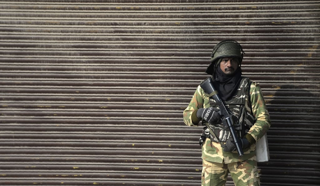 An Indian paramilitary trooper stands guard in front of a closed shop during the third day of strike called by Kashmiri separatists, in Srinagar on December 17. Photo: AFP An Indian paramilitary trooper stands guard in front of a closed shop during the third day of strike called by Kashmiri separatists, in Srinagar on December 17. Photo: AFP