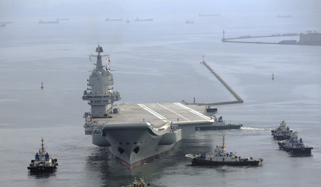 A Type 001A aircraft carrier is towed off a dock at the shipyard in Dalian, Liaoning province, for a sea trial in August. Photo: Handout