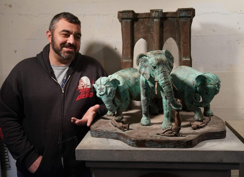 Artist Joseph Reginella poses at his studio in Staten Island, New York, next to his Brooklyn Bridge Elephant Stampede memorial, a recreation in bronze of that fateful day in 1929 when P.T. Barnum’s pack of circus elephants allegedly went rogue, squashing spectators all along the bridge – ‘one of the most horrific land mammal tragedies in our nation’s history’, the plaque says. Photo: AFP Artist Joseph Reginella poses at his studio in Staten Island, New York, next to his Brooklyn Bridge Elephant Stampede memorial, a recreation in bronze of that fateful day in 1929 when P.T. Barnum’s pack of circus elephants allegedly went rogue, squashing spectators all along the bridge – ‘one of the most horrific land mammal tragedies in our nation’s history’, the plaque says. Photo: AFP