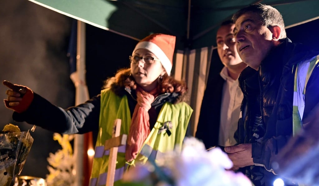 Priest Joseph Nurchi (right) prepares for a Christmas mass for yellow vest protestors near a roundabout in Somain, northern France on December 24, 2018. Photo: AFP