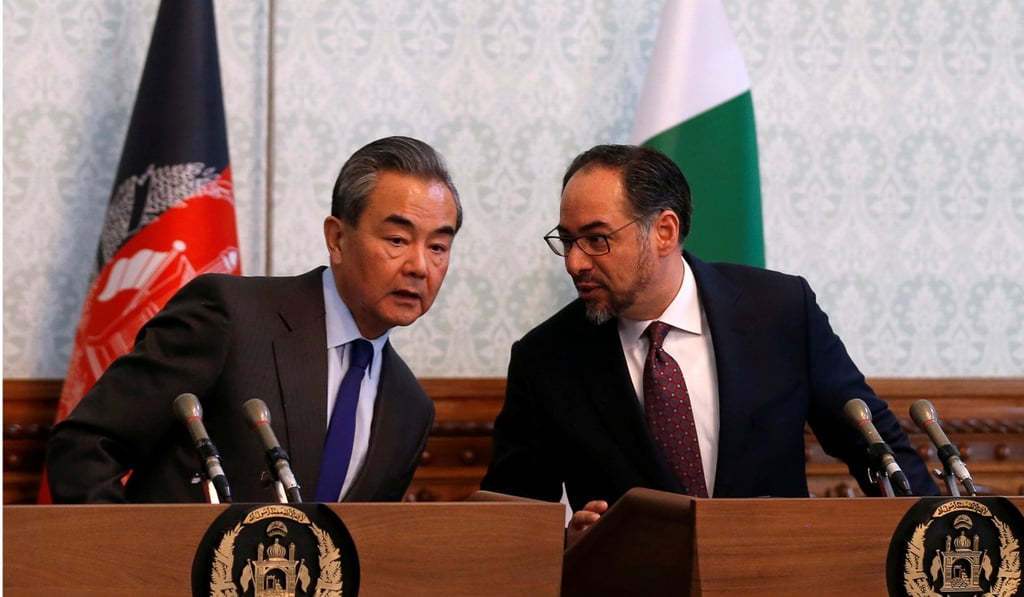 Afghanistan’s Foreign Minister Salahuddin Rabbani chats to China’s Foreign Minister Wang Yi during a news conference in Kabul, Afghanistan on December 15. Photo: Reuters