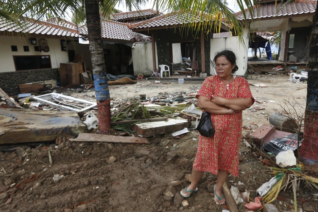 A tsunami survivor stands among debris in a devastated area in Carita, Banten. Photo: EPA A tsunami survivor stands among debris in a devastated area in Carita, Banten. Photo: EPA