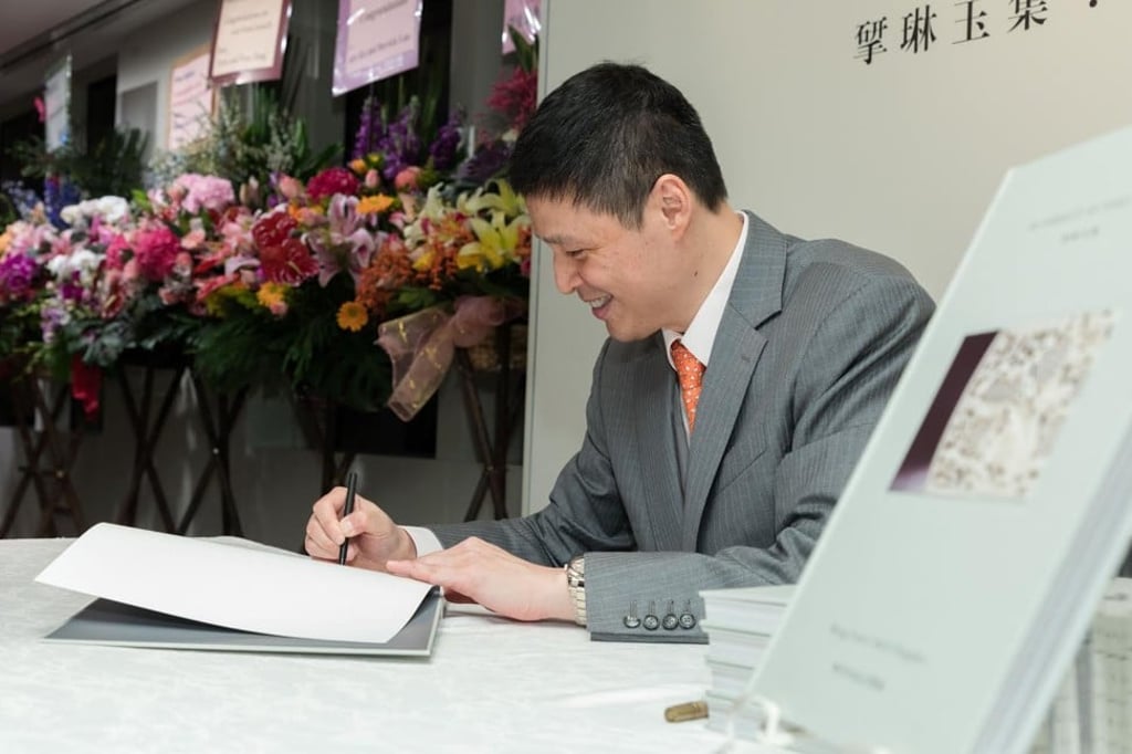 Liu signs his book during its launch.