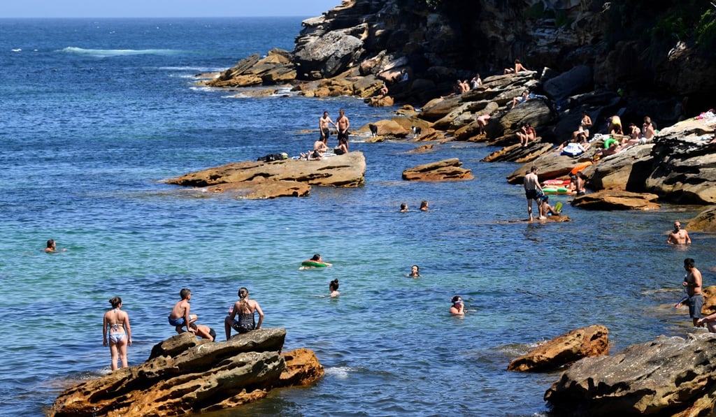 Swimmers take a dip in the sea in Sydney on Friday. Photo: EPA-EFE Swimmers take a dip in the sea in Sydney on Friday. Photo: EPA-EFE