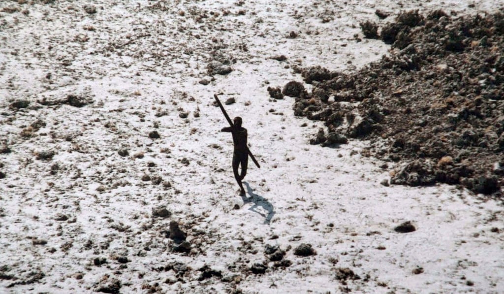 A Sentinelese tribesman aims his bow and arrow at a coastguard helicopter. Photo: AFP