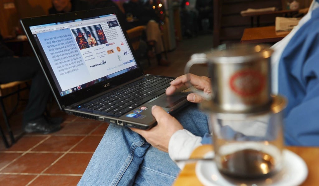 A man uses his laptop at a coffee shop in downtown Hanoi. Photo: AFP