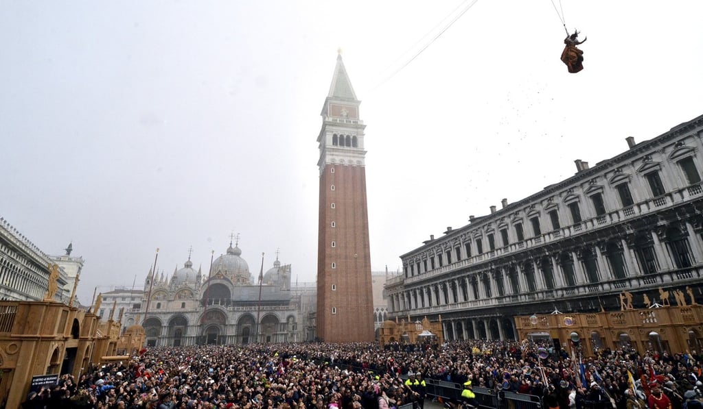 In this 2016 file photo, people fill St Mark's Square in Venice to watch the “Flight of the Angel” ceremony, as a woman dressed in traditional costume descends from the bell tower into the square. Photo: AP In this 2016 file photo, people fill St Mark's Square in Venice to watch the “Flight of the Angel” ceremony, as a woman dressed in traditional costume descends from the bell tower into the square. Photo: AP