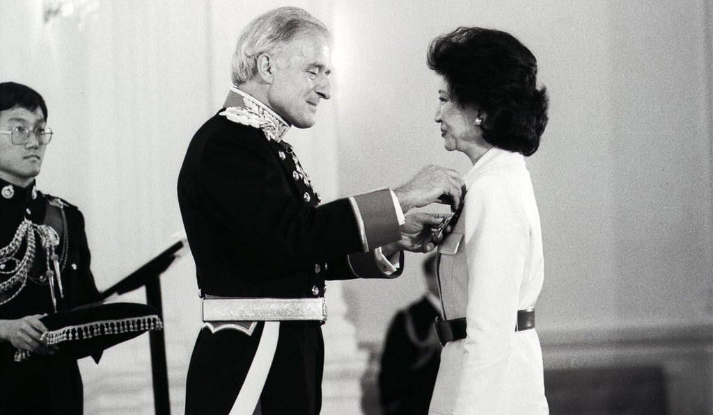Executive councillor Lydia Dunn (right) is presented with the Dame Commander of the Most Excellent Order of the British Empire by governor David Wilson. Photo: SCMP Archive