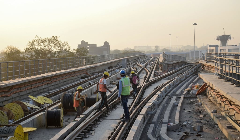 Indian labourers work on a rail link in Ahmedabad. Investors are bullish about emerging markets, which include India. Photo: AFP