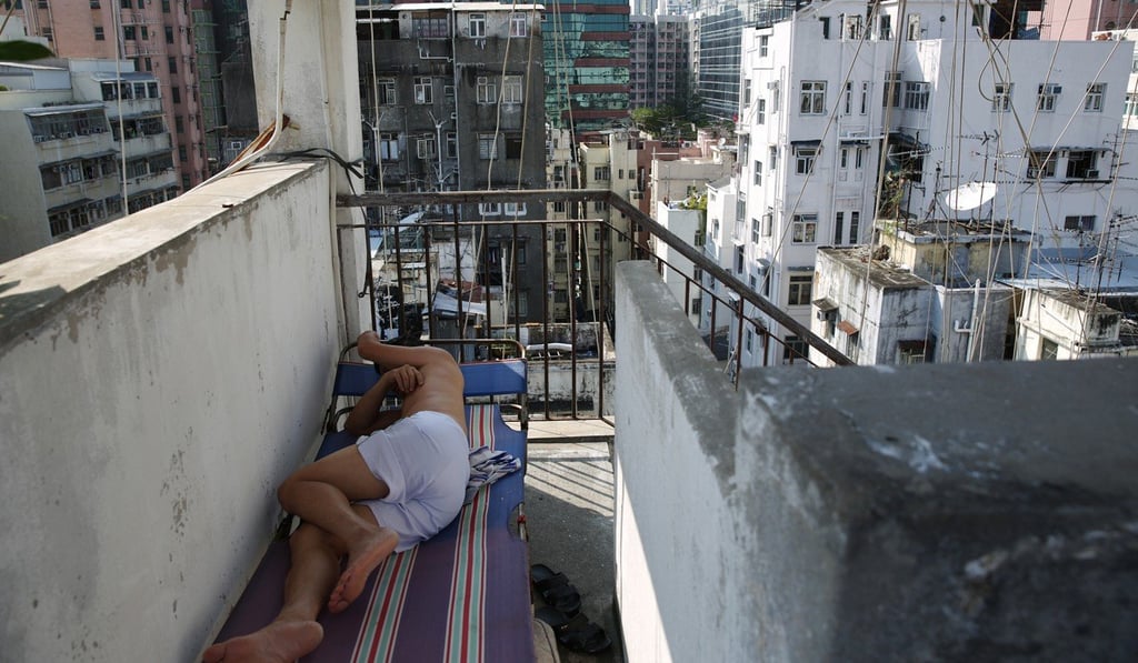 A man sleeps on the roof of an old building in Sham Shui Po. Photo: Sam Tsang