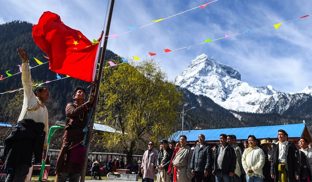 Villagers attend a national flag raising ceremony in Daxing Village of Nyingchi, southwest China’s Tibet Autonomous Region, celebrating Serfs' Emancipation Day. Photo: Xinhua