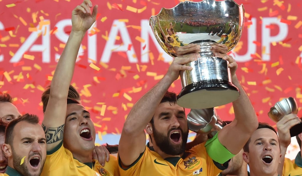 Australia captain Mile Jedinak (C) lifts the AFC Asian Cup after beating South Korea in 2015. Photo: AFP