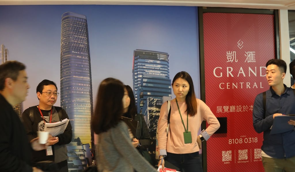 Property agents wait outside the Grand Central development. Photo: Dickson Lee