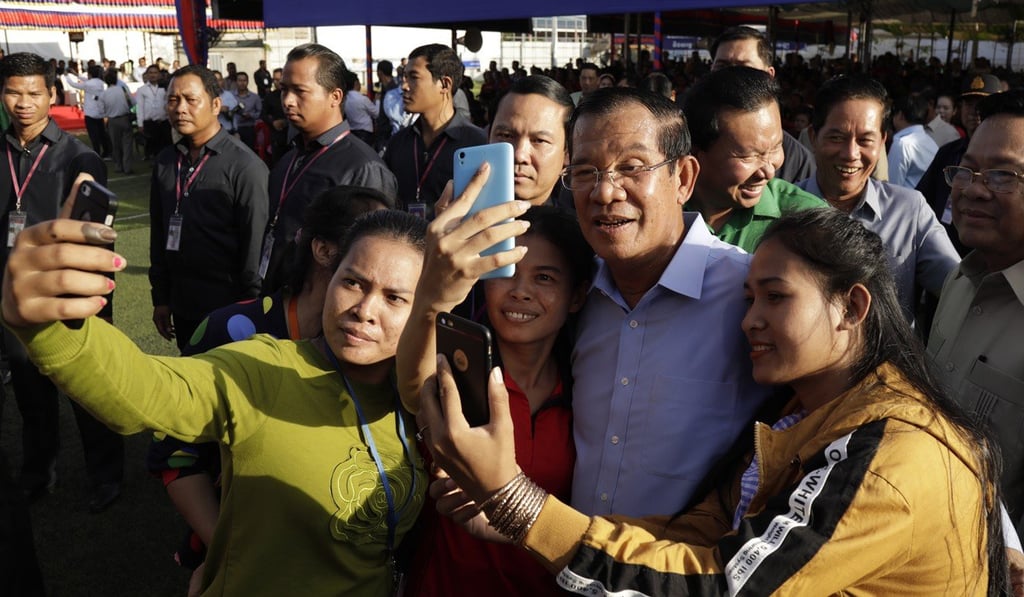 Cambodian Prime Minister Hun Sen poses with garment workers during an event in Phnom Penh in August 2018. Photo: EPA