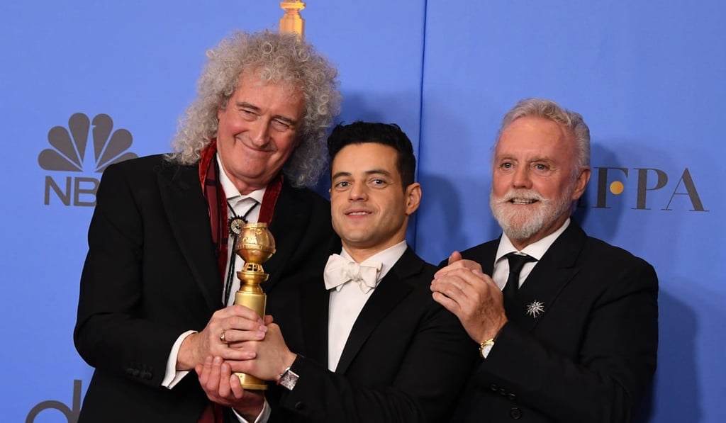 Rami Malek, winner of the Golden Globe for best actor in a dramatic film, poses with his trophy along with Queen band members Brian May (left) and Roger Taylor. Photo: AFP