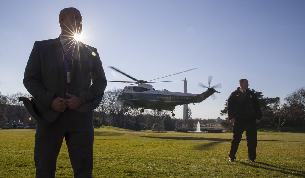 Officers with the US Secret Service stand as Marine One, with US President Donald Trump aboard, departs from the South Lawn of the White House. Photo: AP