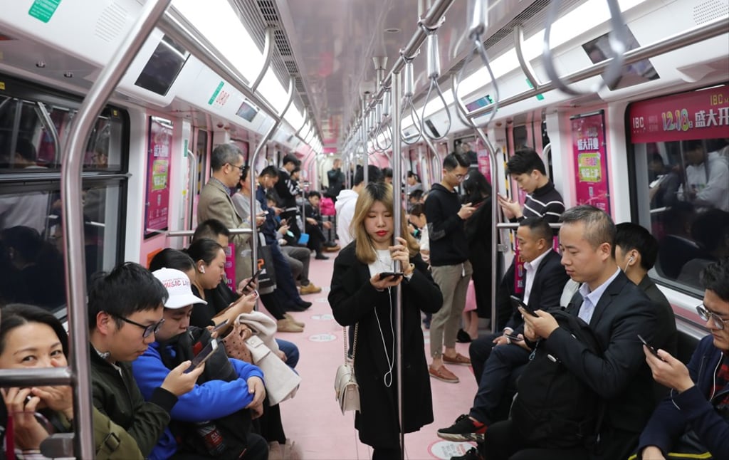 Little social interaction takes place between passengers on public transport, such as metro trains these days, with most people too focused on their mobile phones. Photo: Sam Tsang
