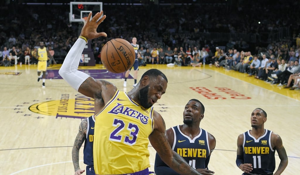 Los Angeles Lakers forward LeBron James follows through on a dunk against the Denver Nuggets. Photo: AP