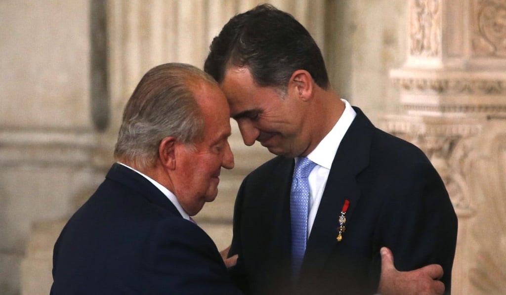 Spain’s King Juan Carlos and his son Crown Prince Felipe (right) hug each other as they attend the signature ceremony of the act of abdication at the Royal Palace in Madrid, in June 2014. Photo: Juan Medina / Files / Reuters